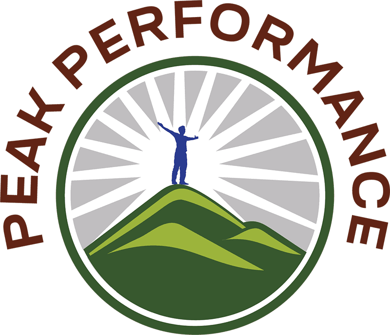 Round logo for Peak Performance. Illustration of an all blue person standing on top of green hills with a white sunburst behind the blue person on a grey background. The words curve around the circle of the logo.