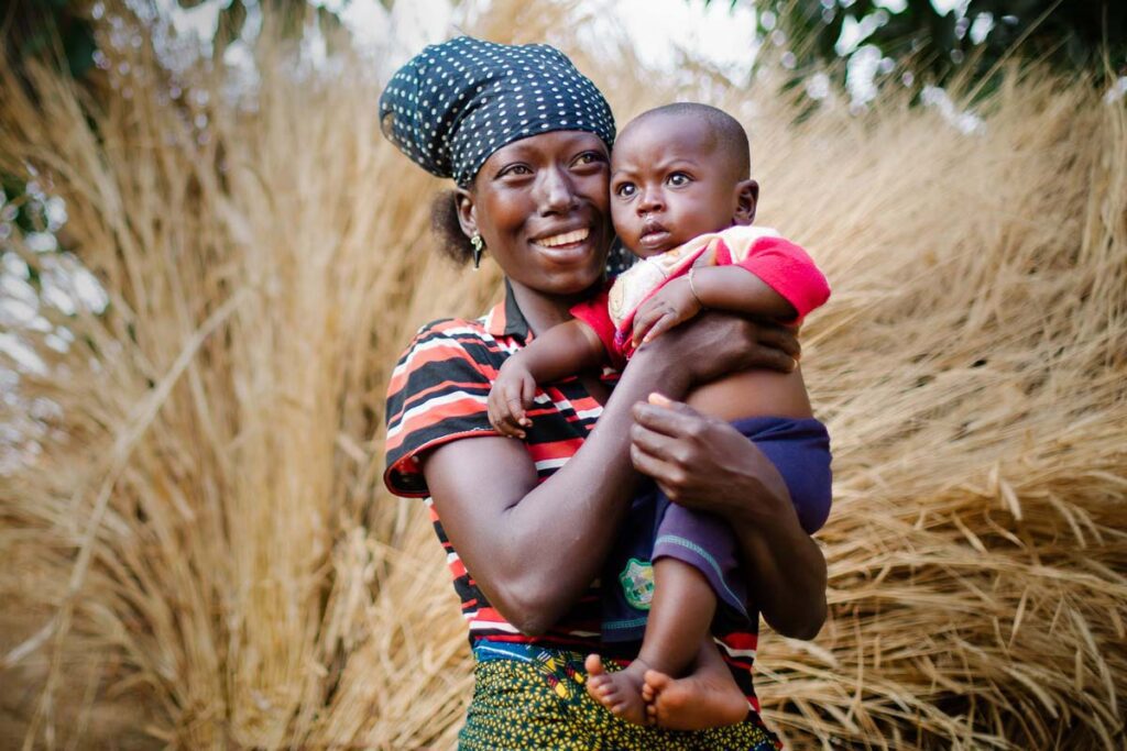 Nigerian mother holding child prenatal vitamins