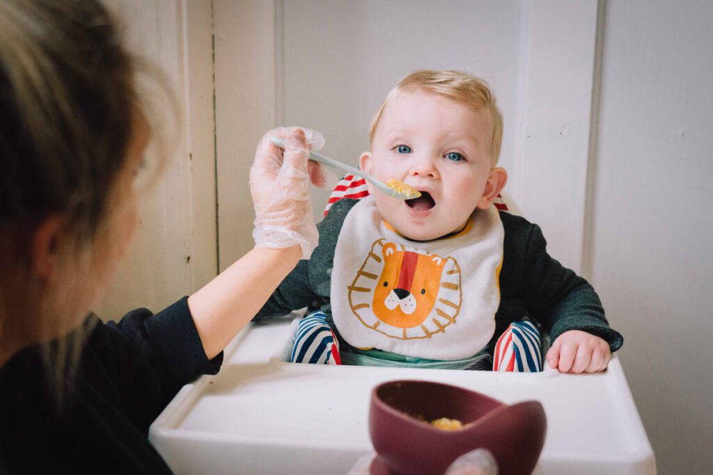 child being fed in United Kingdom supplemental feeding program