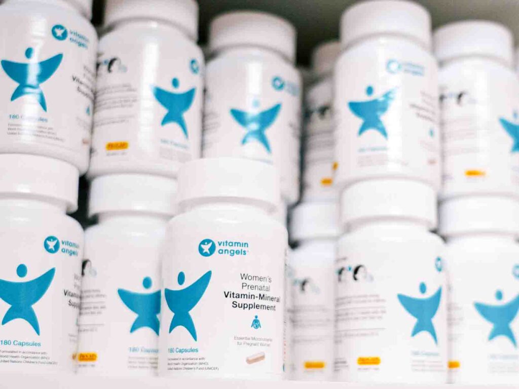 Shelf of bottles of Vitamin Angel multiple micronutrient supplementation