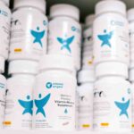 Shelf of bottles of Vitamin Angel multiple micronutrient supplementation
