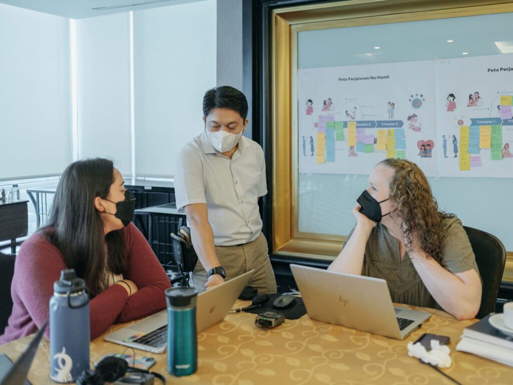 Implementation researchers sitting at a table at a conference.