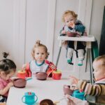 toddlers eating together at nursery in united kingdom