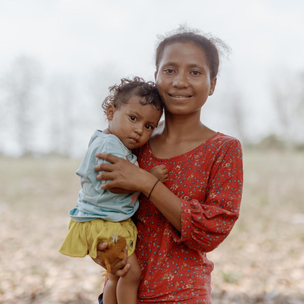 Indonesian mother holding her child.