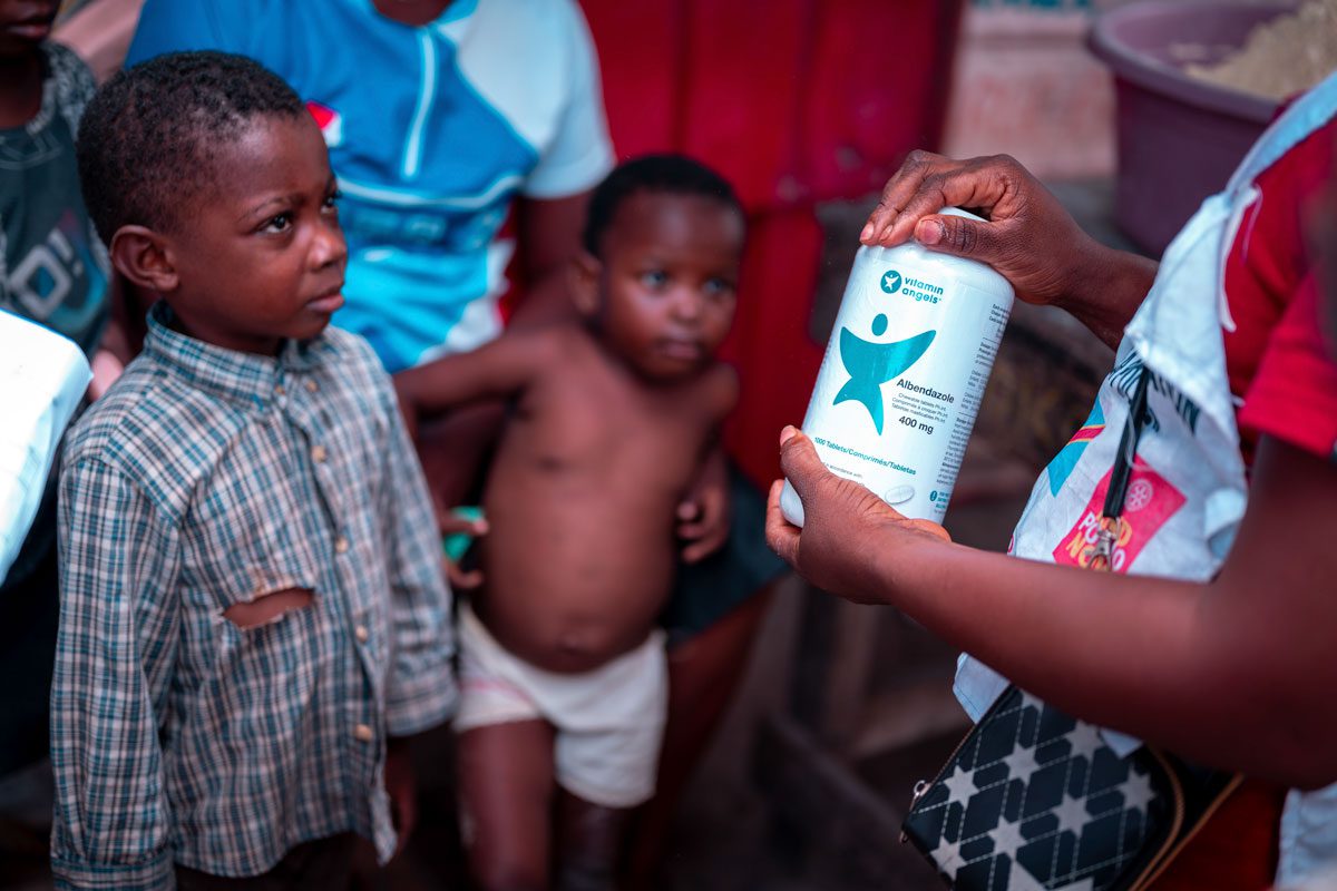 Children receive deworming treatment during a door-to-door distribution in the DRC