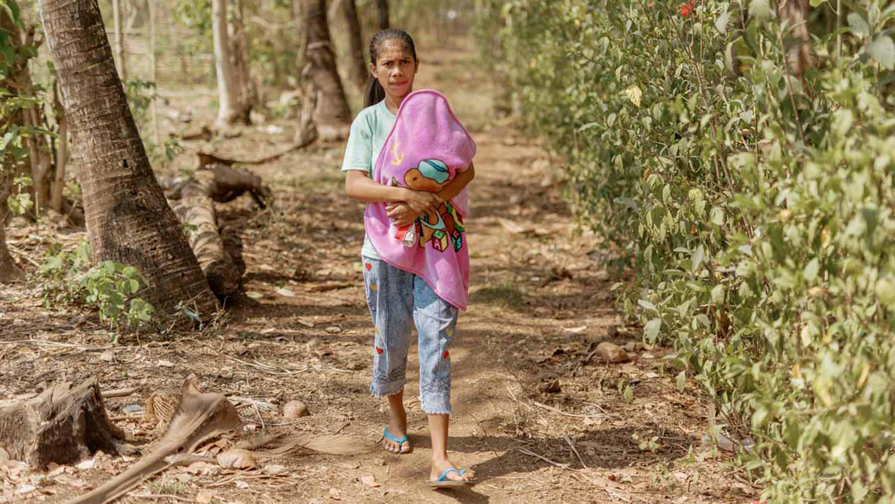 A mom walking with her baby on Sumba Island