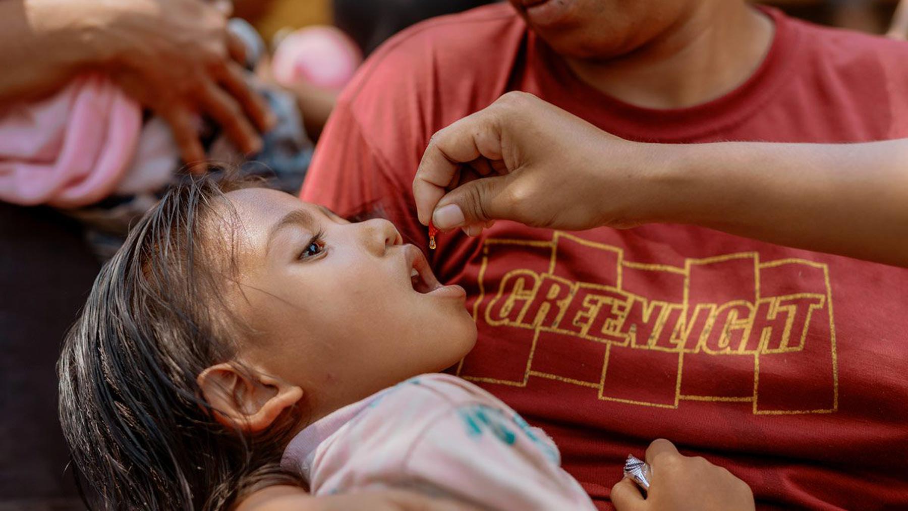 Maria receives vitamin A in her Sumba community