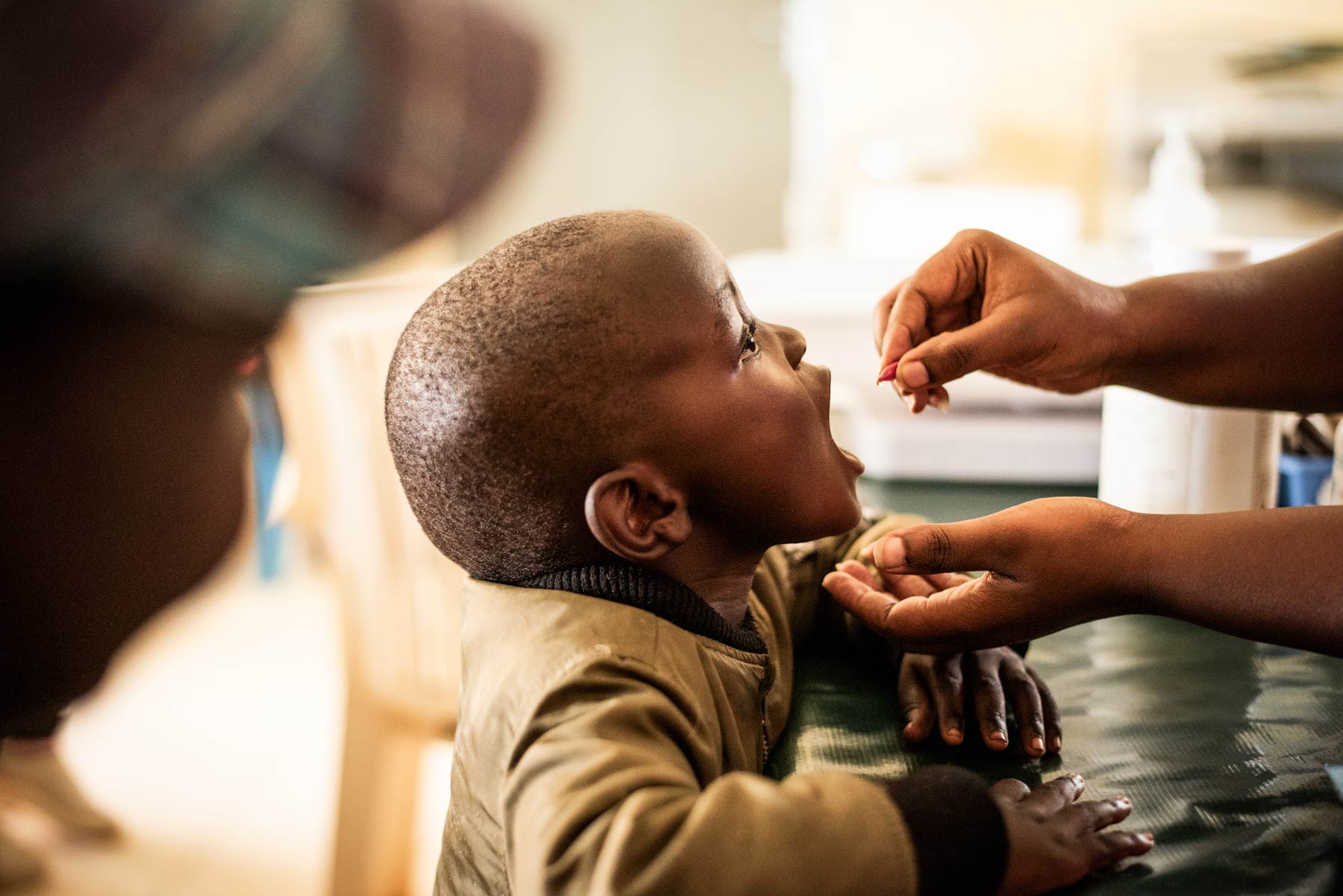 A 3-year-old boy receives a dose of vitamin A at a distribution in Kenya.