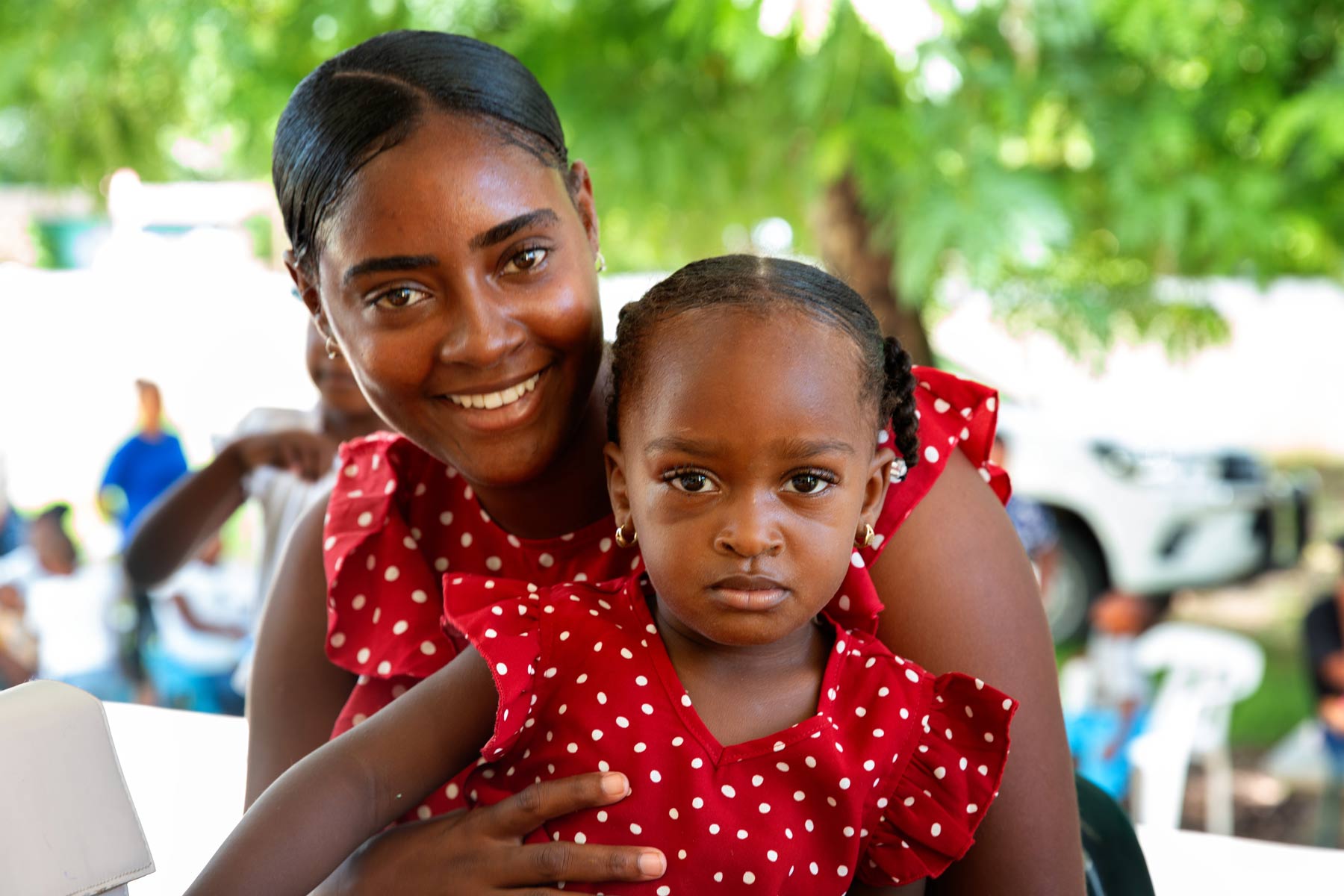 A portrait of a mother and child in matching outfits 