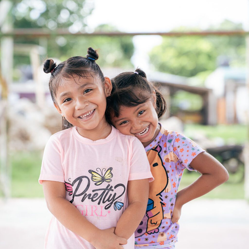 Portrait of two young, smiling girls in Mexico.