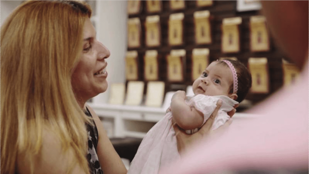 Thumbnail from a b-roll video of a mother holding her infant.