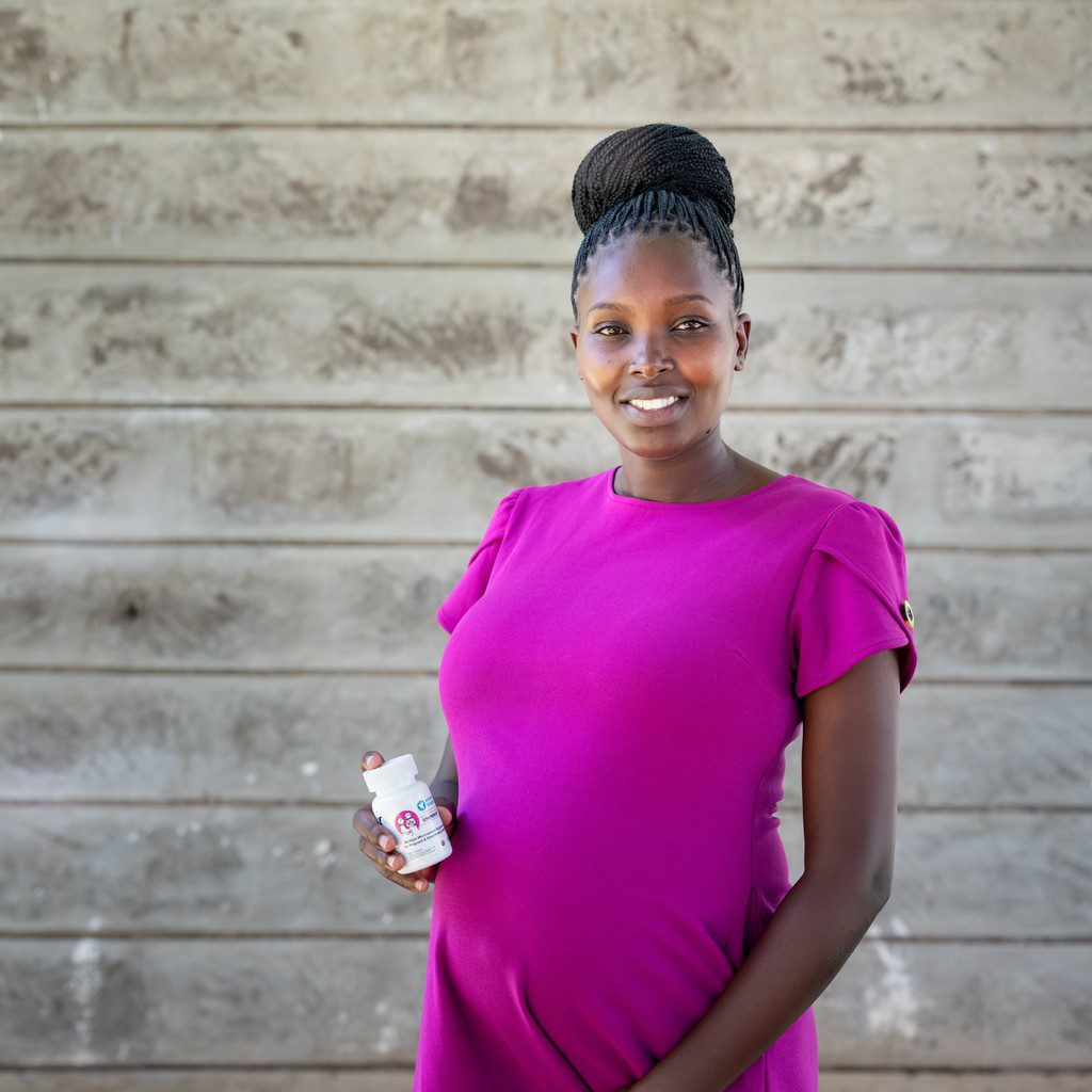 Nancy, holding Multiple Micronutrient Supplements (MMS)